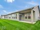 Backyard featuring a lush lawn and covered porch for outdoor enjoyment at 275 Hunters Ridge Dr, Danville, IN 46122