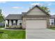Charming single-story home with a two-car garage, well-manicured lawn, and brick accents at 275 Hunters Ridge Dr, Danville, IN 46122