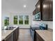 Bright kitchen with stainless steel appliances, dark cabinets, and a view to the backyard at 275 Hunters Ridge Dr, Danville, IN 46122
