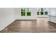 Bright living space with wood floors and a view of the greenery through multiple windows at 275 Hunters Ridge Dr, Danville, IN 46122