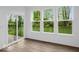 Bright living room featuring luxury vinyl plank flooring, sliding glass doors, and large windows providing ample natural light at 275 Hunters Ridge Dr, Danville, IN 46122