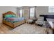Comfortable bedroom with two windows and accent chairs provides a relaxing retreat at 3039 Armory Dr, Indianapolis, IN 46208