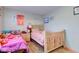 A colorful bedroom with twin beds and wood floor at 3039 Armory Dr, Indianapolis, IN 46208
