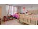 A colorful bedroom with twin beds and soft, natural light at 3039 Armory Dr, Indianapolis, IN 46208