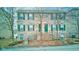 Charming brick townhome with green shutters and door at 3039 Armory Dr, Indianapolis, IN 46208