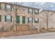 Inviting townhome with brick facade and green door and shutters at 3039 Armory Dr, Indianapolis, IN 46208