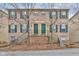 Inviting brick townhome featuring green shutters and doors at 3039 Armory Dr, Indianapolis, IN 46208