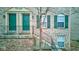 Charming brick townhome with green shutters and door at 3039 Armory Dr, Indianapolis, IN 46208