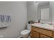 This powder room features a wood vanity, mirror and gray walls at 3039 Armory Dr, Indianapolis, IN 46208