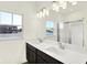 Bathroom showcasing a double sink vanity, large mirror, modern lighting and shower at 3687 Thomas Jefferson Ct, Westfield, IN 46074