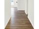A light and airy hallway shows clean white walls and attractive wood laminate flooring at 3687 Thomas Jefferson Ct, Westfield, IN 46074