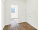 Hallway view showing a carpeted bedroom and hard surface flooring at 3687 Thomas Jefferson Ct, Westfield, IN 46074