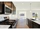 Modern kitchen with stainless steel appliances, island sink, and hardwood flooring at 3687 Thomas Jefferson Ct, Westfield, IN 46074