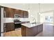 Bright kitchen featuring stainless steel appliances, island with sink, and modern fixtures at 3687 Thomas Jefferson Ct, Westfield, IN 46074