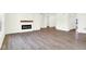 Spacious living room with a fireplace, wood laminate flooring, and white trim at 3687 Thomas Jefferson Ct, Westfield, IN 46074