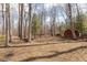 A backyard with trees and a red shed at 3810 Springfield Overlook St, Indianapolis, IN 46234