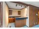 Basement bar area includes lighting, wood paneling, storage cabinets, and a countertop at 3810 Springfield Overlook St, Indianapolis, IN 46234