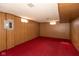Retro basement featuring red carpeting and wood paneling at 3810 Springfield Overlook St, Indianapolis, IN 46234