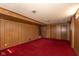 Spacious basement featuring retro wood paneling and red carpeting at 3810 Springfield Overlook St, Indianapolis, IN 46234