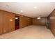 Spacious basement featuring retro wood paneling and neutral carpeting at 3810 Springfield Overlook St, Indianapolis, IN 46234