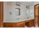 The bathroom features dual sinks, vintage-style fixtures, and a charming wallpapered design at 3810 Springfield Overlook St, Indianapolis, IN 46234