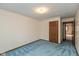 Bedroom featuring blue carpet, neutral walls, and a door leading to an adjacent room at 3810 Springfield Overlook St, Indianapolis, IN 46234