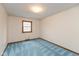 Cozy bedroom featuring blue carpet, neutral walls, and a window providing natural light at 3810 Springfield Overlook St, Indianapolis, IN 46234