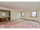 A spacious bedroom featuring an en suite vanity, wallpapered walls, and natural light from two windows at 3810 Springfield Overlook St, Indianapolis, IN 46234