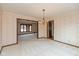 Dining room with elegant lighting, chair rail and trimmed doorway to the living room at 3810 Springfield Overlook St, Indianapolis, IN 46234