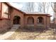 Close-up of a red brick house featuring an arched portico, steps and a well-manicured lawn at 3810 Springfield Overlook St, Indianapolis, IN 46234