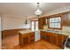 Cozy kitchen featuring light countertops, wood cabinets and a window providing natural light at 3810 Springfield Overlook St, Indianapolis, IN 46234