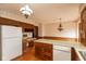 Spacious kitchen featuring wood cabinets, an island with a dishwasher, and access to dining area at 3810 Springfield Overlook St, Indianapolis, IN 46234