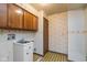 Laundry room features yellow wallpaper, and vintage cabinet at 3810 Springfield Overlook St, Indianapolis, IN 46234