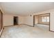 Large living area showcasing neutral carpet, a trimmed room divider and classic wall paper at 3810 Springfield Overlook St, Indianapolis, IN 46234