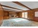 Living room featuring carpet, wooden walls, fireplace with built-in bookshelves and natural light from window at 3810 Springfield Overlook St, Indianapolis, IN 46234