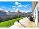 Inviting backyard features a wooden deck, green lawn, and fenced perimeter for privacy at 4051 Presidio Cir, Indianapolis, IN 46235
