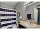 Well-maintained bathroom with a vanity, mirror, and shower with a striped curtain at 4051 Presidio Cir, Indianapolis, IN 46235