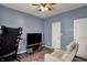 Cozy bedroom with ceiling fan, adjacent TV and comfortable seating, bathed in natural light at 4051 Presidio Cir, Indianapolis, IN 46235