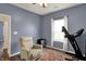 Comfortable bedroom featuring a ceiling fan, seating, and natural light from the window at 4051 Presidio Cir, Indianapolis, IN 46235