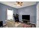 Cozy bedroom with ceiling fan, adjacent TV, and comfortable seating for relaxation at 4051 Presidio Cir, Indianapolis, IN 46235