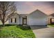 Charming one-story home featuring a two-car garage, green lawn, and neutral siding at 4051 Presidio Cir, Indianapolis, IN 46235
