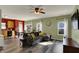 Open living room featuring hardwood floors, modern furniture, adjacent dining area, and lots of natural light at 4051 Presidio Cir, Indianapolis, IN 46235