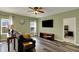 Bright living room featuring hardwood floors, modern furnishings, and a ceiling fan at 4051 Presidio Cir, Indianapolis, IN 46235