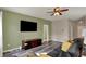 Contemporary living room featuring hardwood floors, modern entertainment center, and ceiling fan at 4051 Presidio Cir, Indianapolis, IN 46235