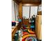 Sunroom with colorful rug, ready to be repurposed and renewed with TLC at 428 N Alton Ave, Indianapolis, IN 46222