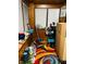 Sunroom with colorful rug, ready to be repurposed and renewed with TLC at 428 N Alton Ave, Indianapolis, IN 46222