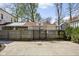 A backyard space with a basketball hoop and court behind a wooden fence with mature trees at 4310 Central Ave, Indianapolis, IN 46205