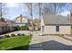 A view of the backyard with a garage, a lawn, and stepping stones leading to the house at 4310 Central Ave, Indianapolis, IN 46205
