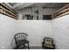 Wine storage area in basement features wine racks, vintage chairs, and a white painted brick wall at 4310 Central Ave, Indianapolis, IN 46205