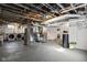 Unfinished basement with exposed ductwork, white brick walls, and utilities, including a washer and dryer at 4310 Central Ave, Indianapolis, IN 46205